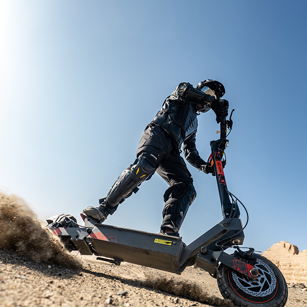 Rider using the KuKirin G2 Ultra on gravel terrain