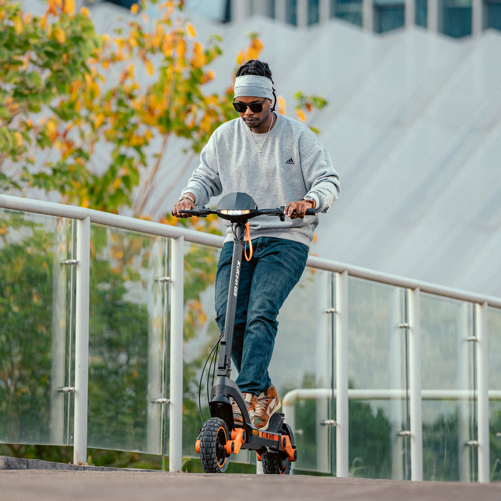 Rider using the KuKirin G3 electric scooter in an urban setting