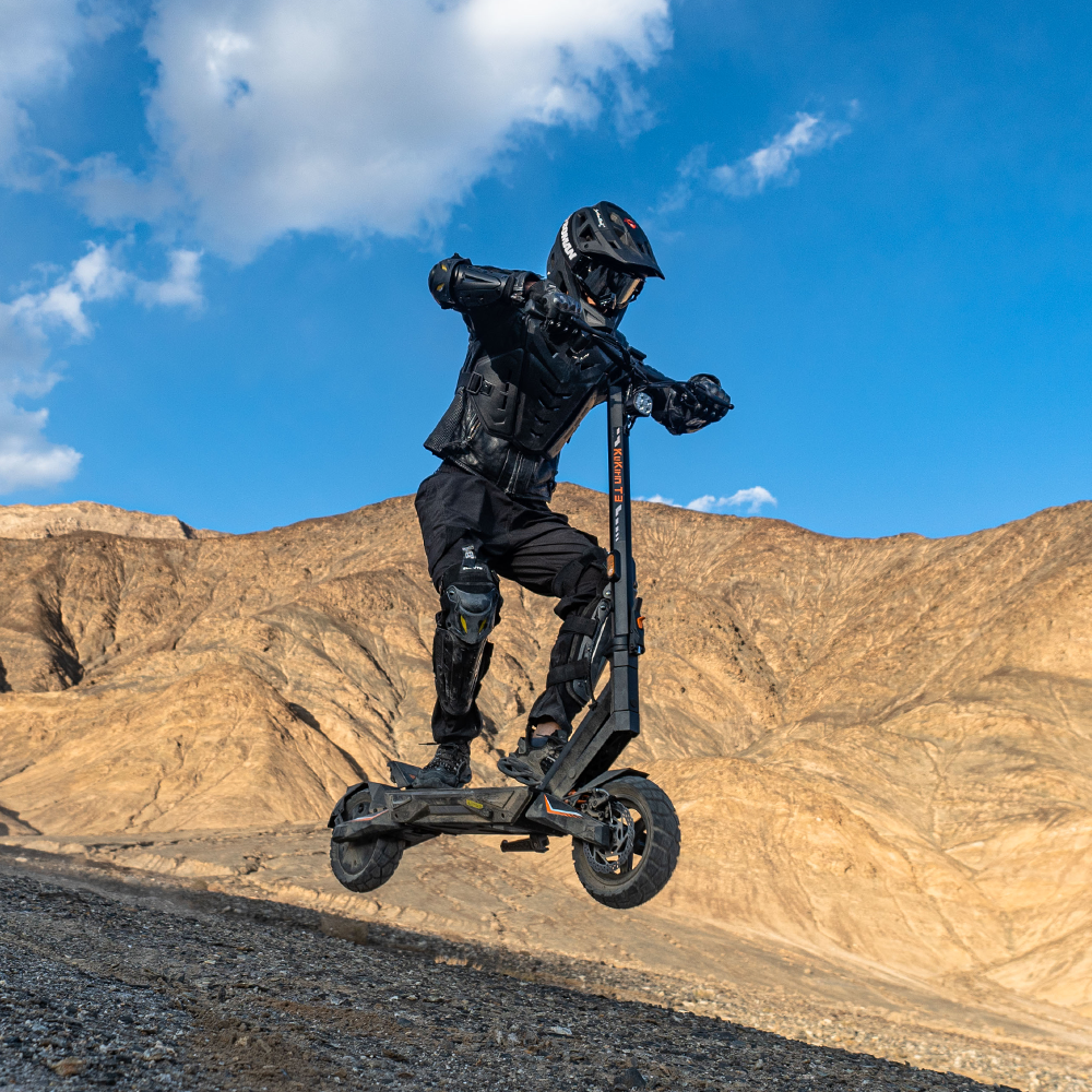 Rider jumping with the KuKirin T3 electric scooter off-road